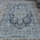 Beige 6' x 10' vintage turkish rug in wool and cotton, shown on the floor.