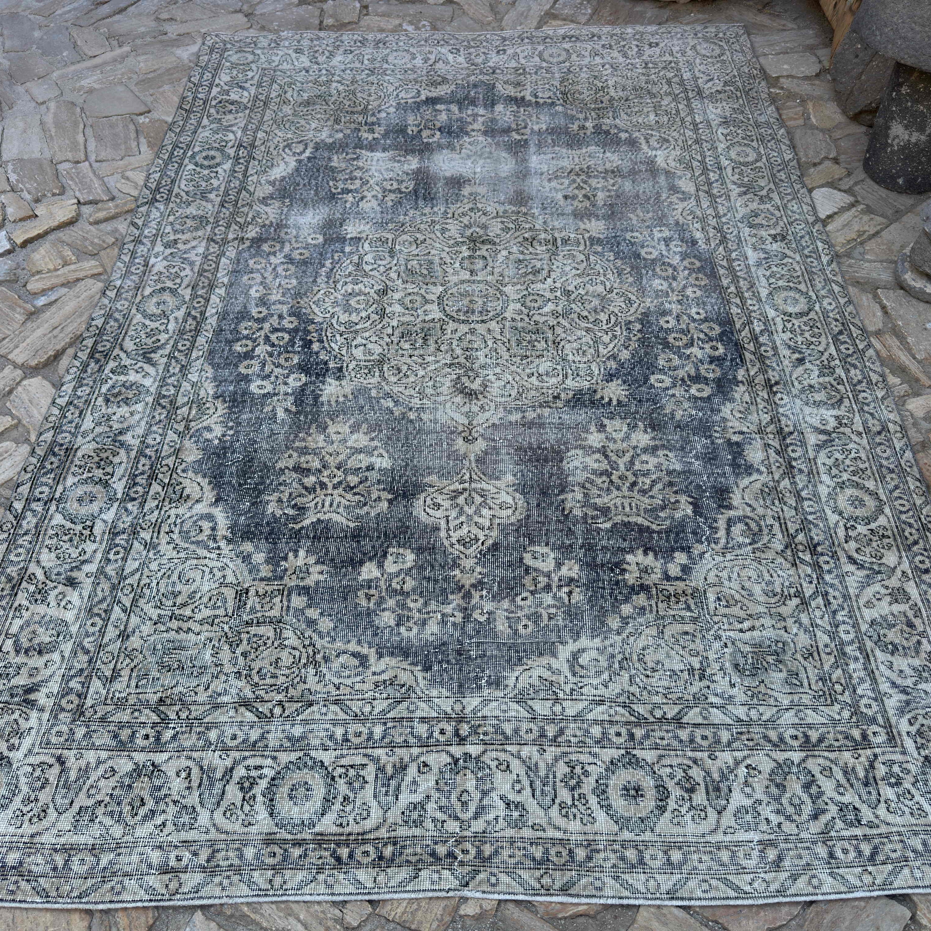 Beige 6' x 10' vintage turkish rug in wool and cotton, shown on the floor.