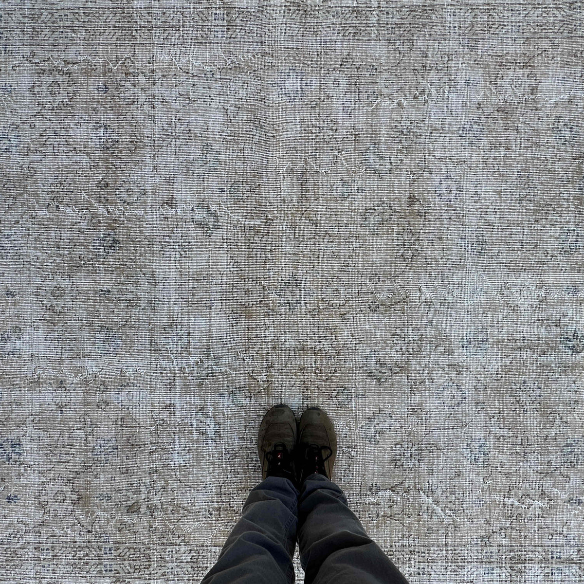 1970s beige vintage turkish rug with floral design, hand-knotted weave and low pile.