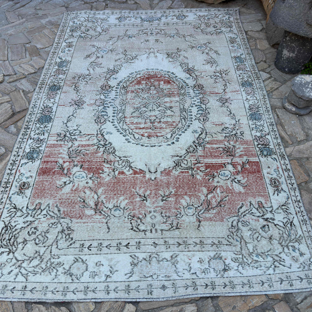 Beige 6' x 10' vintage turkish rug in wool and cotton, shown on the floor.