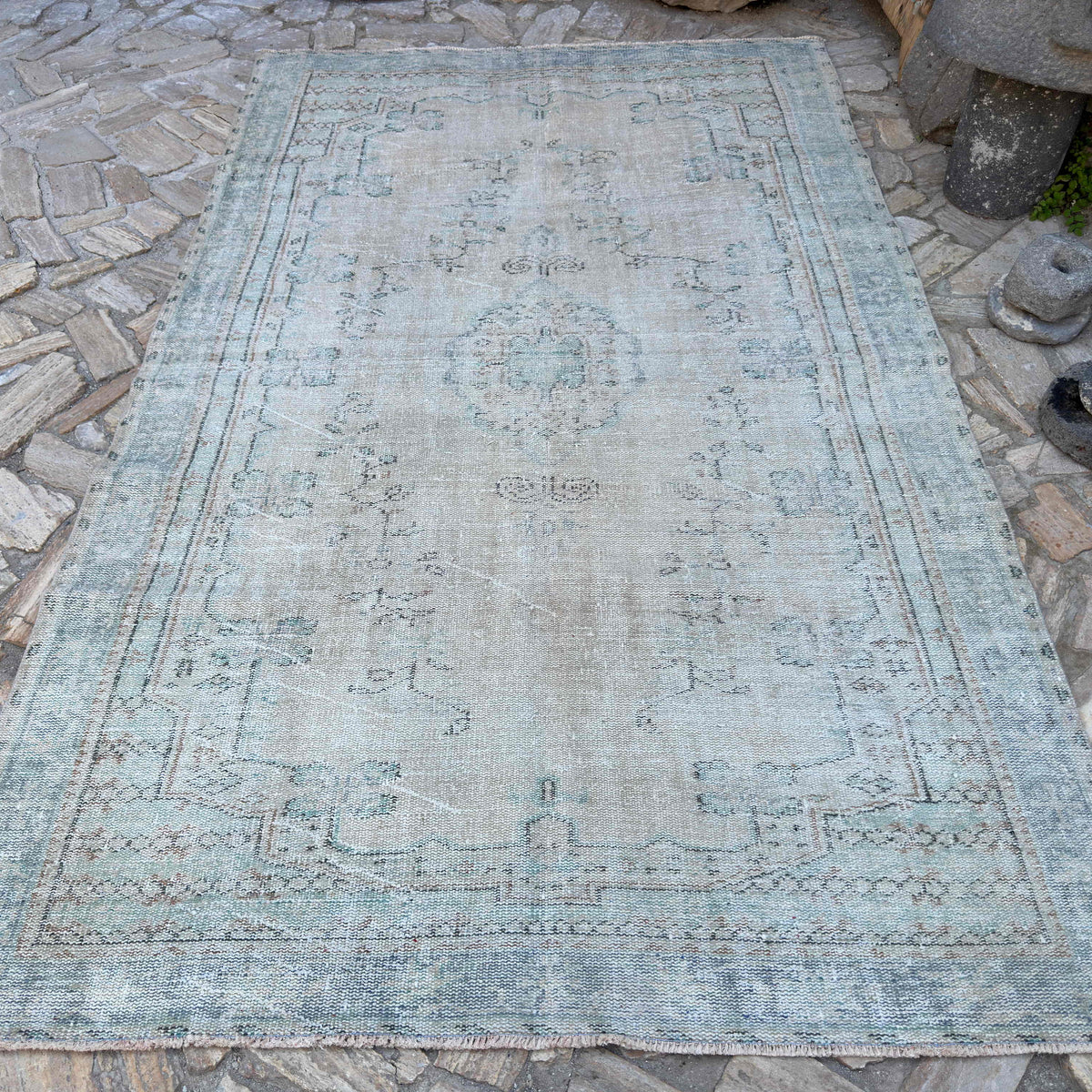 Beige 6' x 10' vintage turkish rug in wool and cotton, shown on the floor.