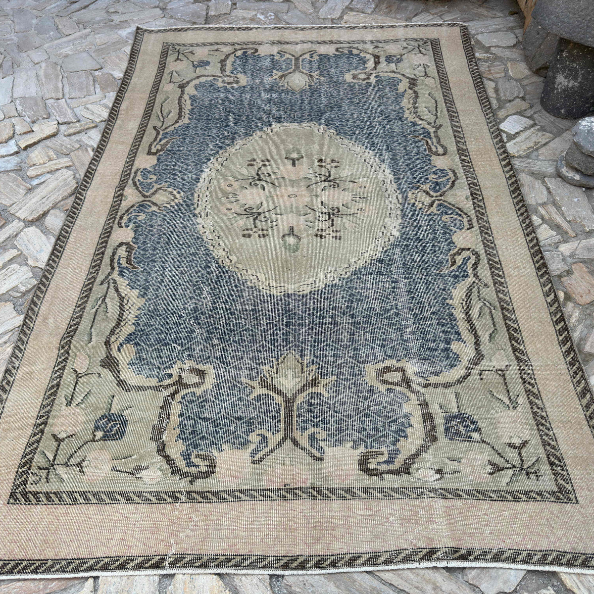 Blue 6' x 10' vintage turkish rug in wool and cotton, shown on the floor.