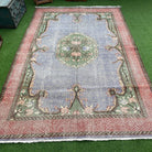 Blue 6' x 10' vintage turkish rug in wool and cotton, shown on the floor.