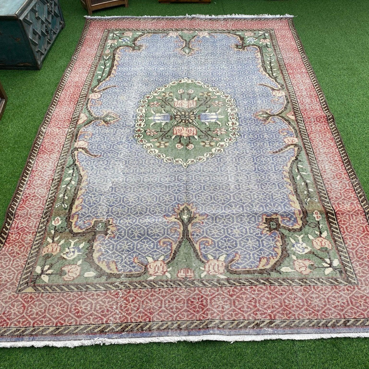 Blue 6' x 10' vintage turkish rug in wool and cotton, shown on the floor.