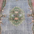 1970s blue vintage turkish rug with medallion design, hand-knotted weave and low pile.