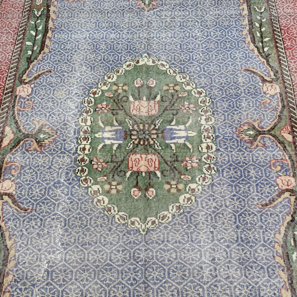1970s blue vintage turkish rug with medallion design, hand-knotted weave and low pile.