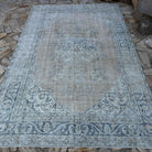 Blue 6' x 10' vintage turkish rug in wool and cotton, shown on the floor.