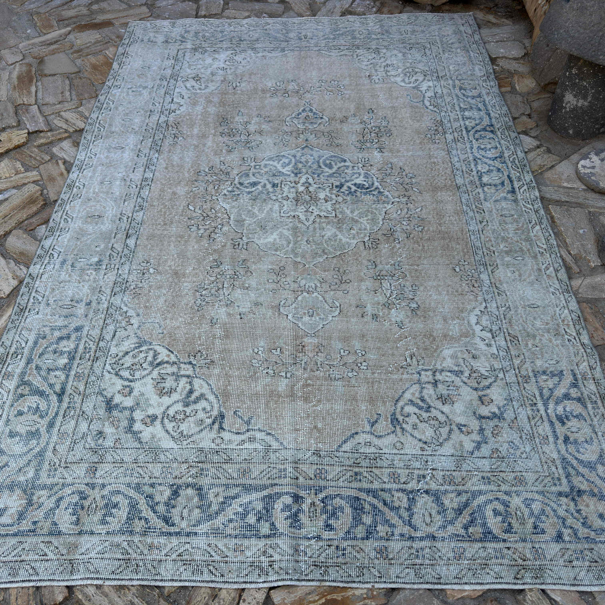 Blue 6' x 10' vintage turkish rug in wool and cotton, shown on the floor.