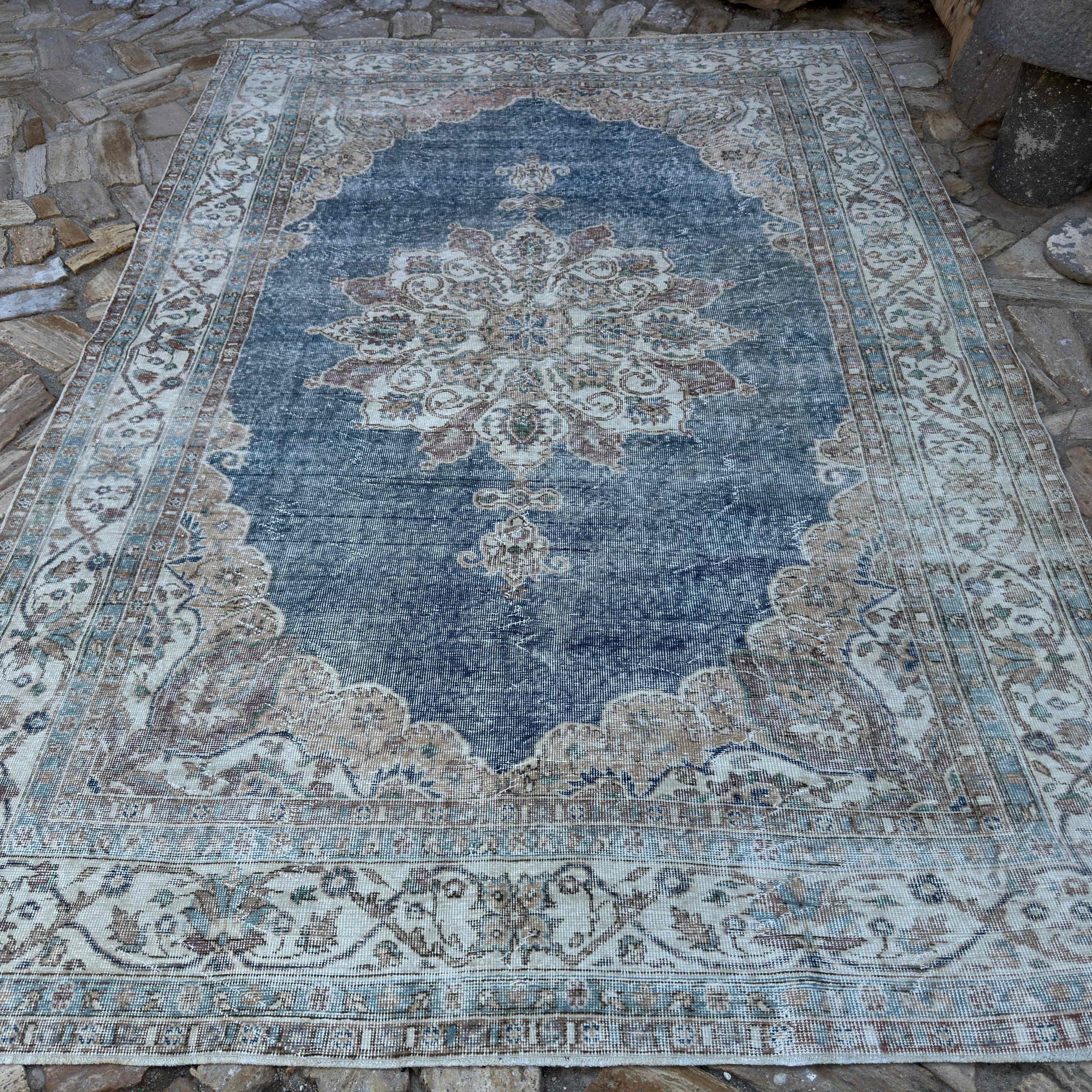 Blue 6' x 10' vintage turkish rug in wool and cotton, shown on the floor.