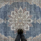 1970s blue vintage turkish rug with medallion design, hand-knotted weave and low pile.