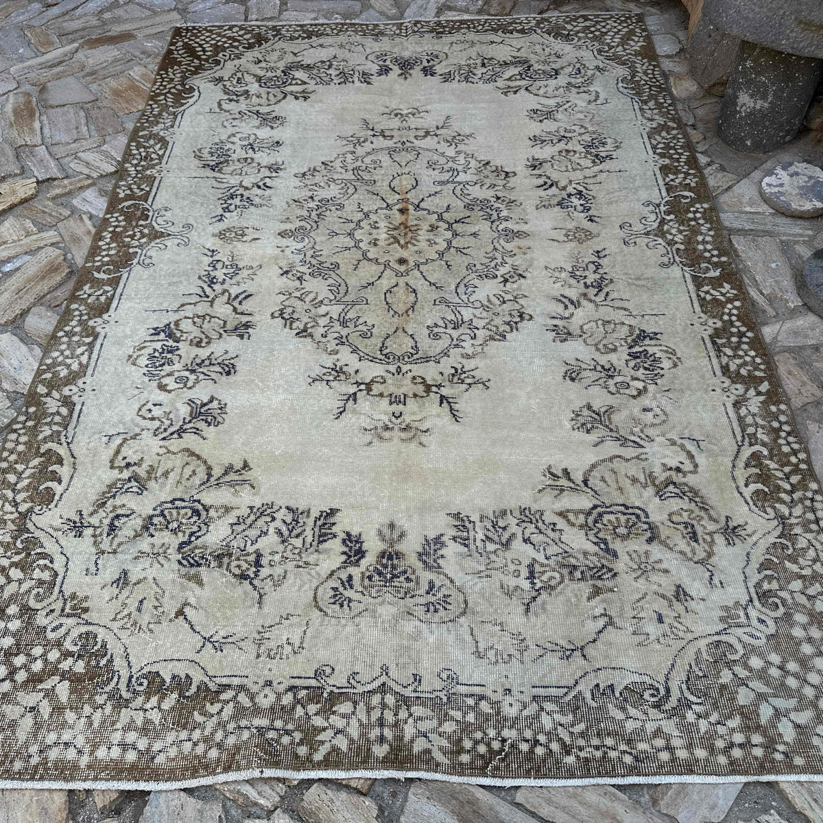 Brown 6' x 10' vintage turkish rug in wool and cotton, shown on the floor.