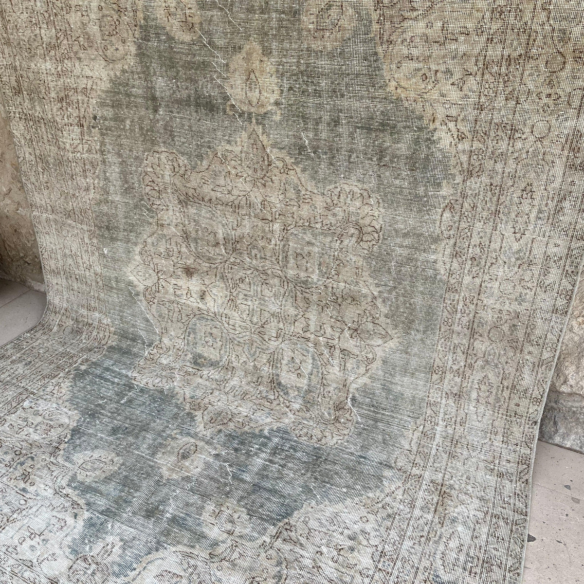 Gray 6' x 10' vintage turkish rug in wool and cotton, shown on the floor.