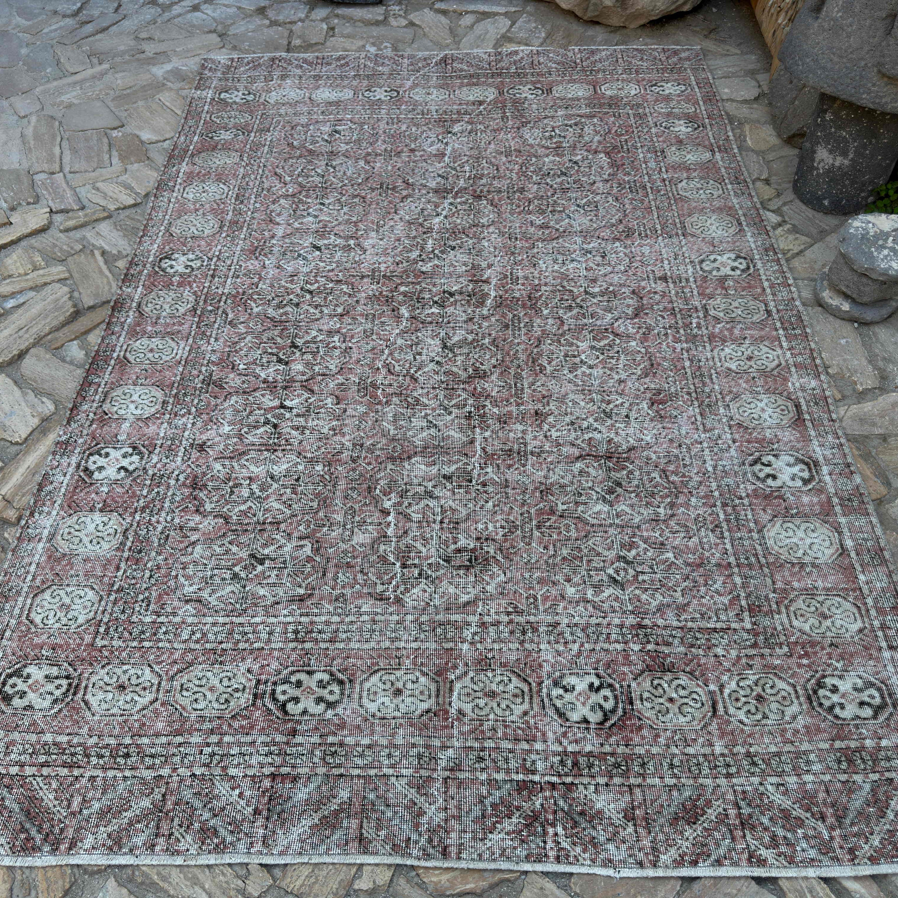 Red 6' x 10' vintage turkish rug in wool and cotton, shown on the floor.
