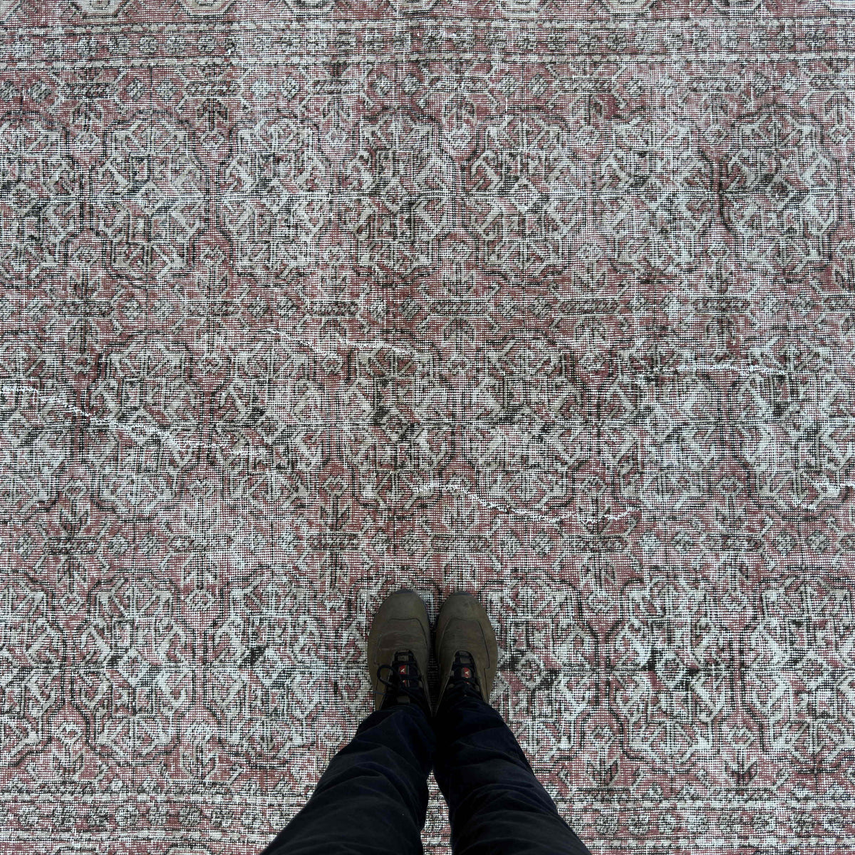 1970s red vintage turkish rug with floral design, hand-knotted weave and low pile.