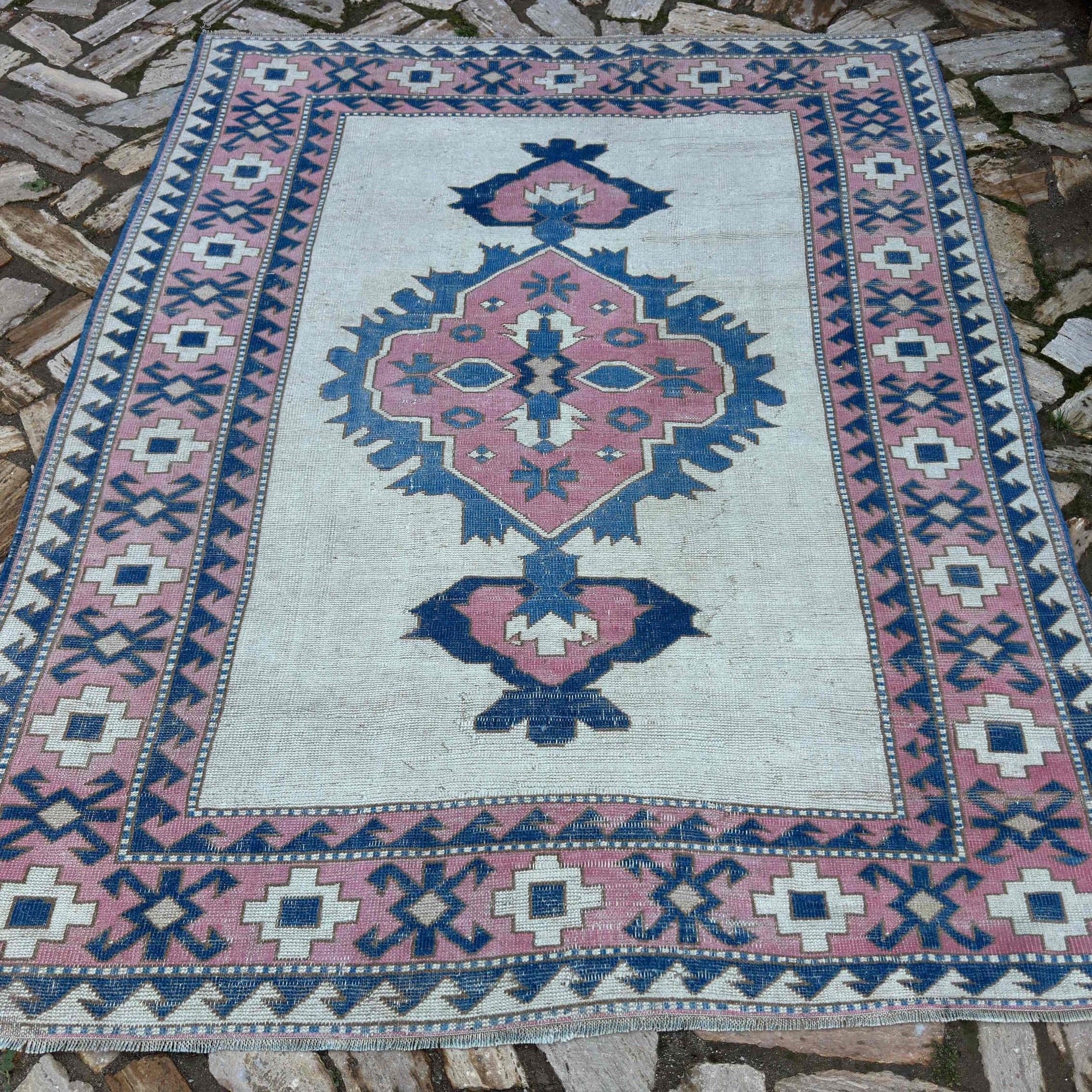 Pink 6' x 7' vintage turkish rug in wool and cotton, shown on the floor.