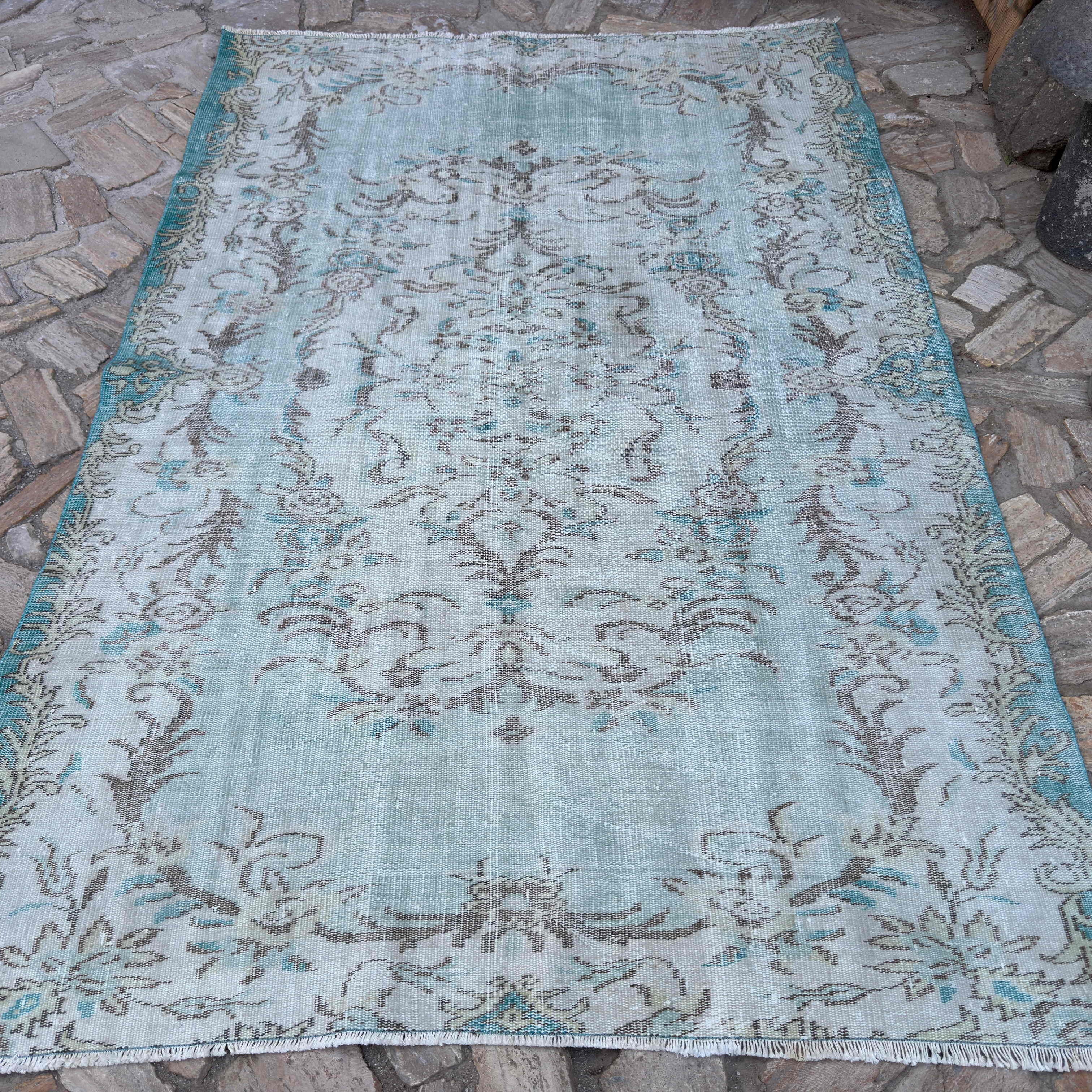 Blue 6' x 8' vintage turkish rug in wool and cotton, shown on the floor.