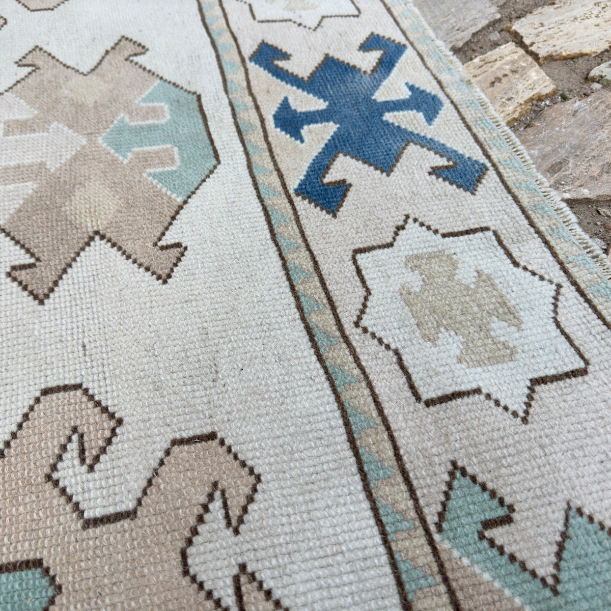 Close-up of the blue vintage turkish rug showing traditional details, hand-knotted weave, wool and cotton and low pile.