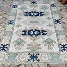 Blue 6' x 8' vintage turkish rug in wool and cotton, shown on the floor.