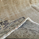 Close-up of the blue vintage turkish rug showing medallion details, hand-knotted weave, wool and cotton and low pile.