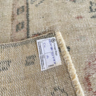 1970s beige vintage turkish rug with medallion design, hand-knotted weave and low pile.
