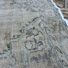 Close-up of the beige vintage turkish rug showing neutral details, hand-knotted weave, wool and cotton and low pile.