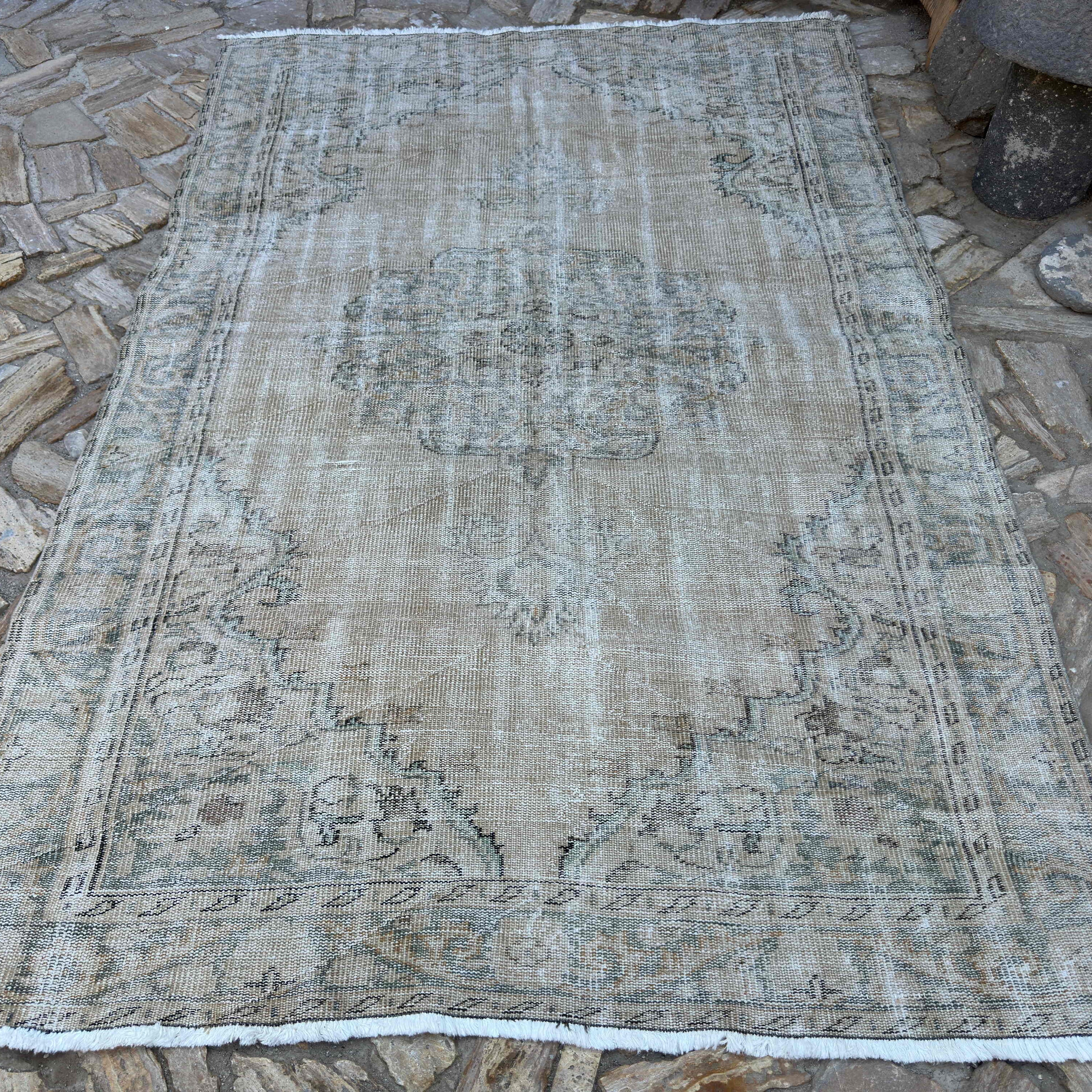 Beige 6' x 9' vintage turkish rug in wool and cotton, shown on the floor.