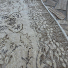 Close-up of the beige vintage turkish rug showing neutral details, hand-knotted weave, wool and cotton and low pile.
