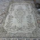 Beige 6' x 9' vintage turkish rug in wool and cotton, shown on the floor.
