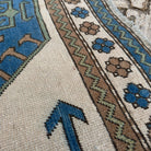 Close-up of the blue vintage turkish rug showing traditional details, hand-knotted weave, wool and cotton and low pile.