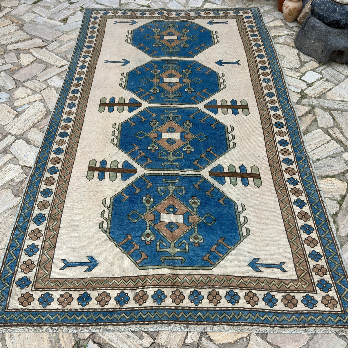 Blue 6' x 9' vintage turkish rug in wool and cotton, shown on the floor.