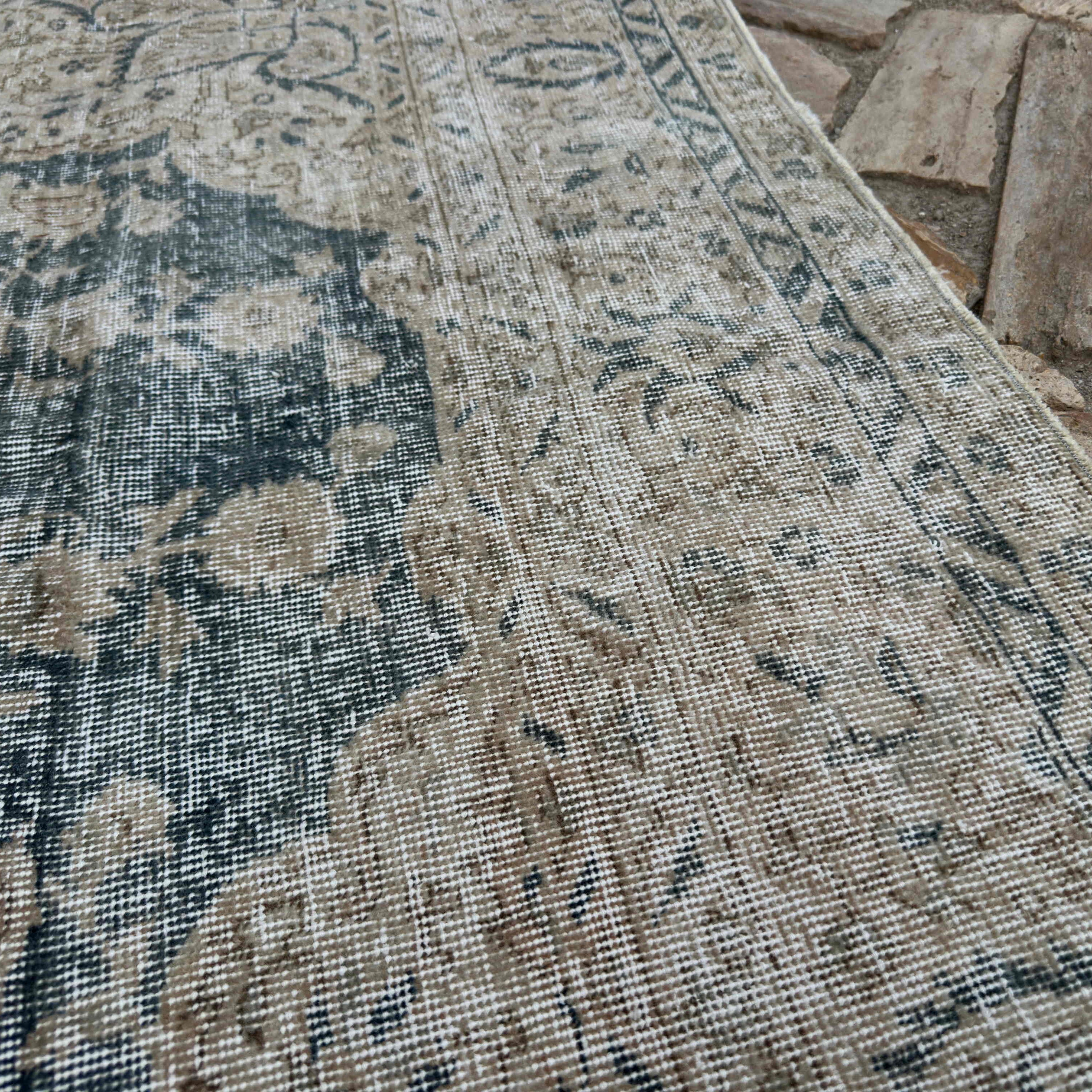 Close-up of the blue vintage turkish rug showing medallion details, hand-knotted weave, wool and cotton and low pile.