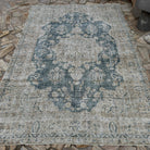 Blue 6' x 9' vintage turkish rug in wool and cotton, shown on the floor.