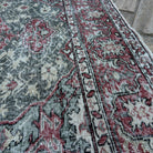 Close-up of the green vintage turkish rug showing traditional details, hand-knotted weave, wool and cotton and low pile.