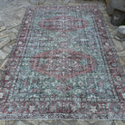 Green 6' x 9' vintage turkish rug in wool and cotton, shown on the floor.