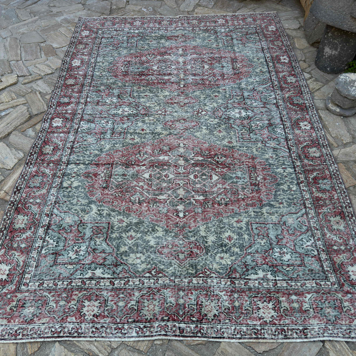 Green 6' x 9' vintage turkish rug in wool and cotton, shown on the floor.