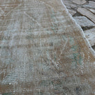 Close-up of the pale orange vintage turkish rug showing traditional details, hand-knotted weave, wool and cotton and low pile.