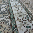 Close-up of the yellow vintage turkish rug showing traditional details, hand-knotted weave, wool and cotton and low pile.