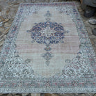 Beige 7' x 10' vintage turkish rug in wool and cotton, shown on the floor.