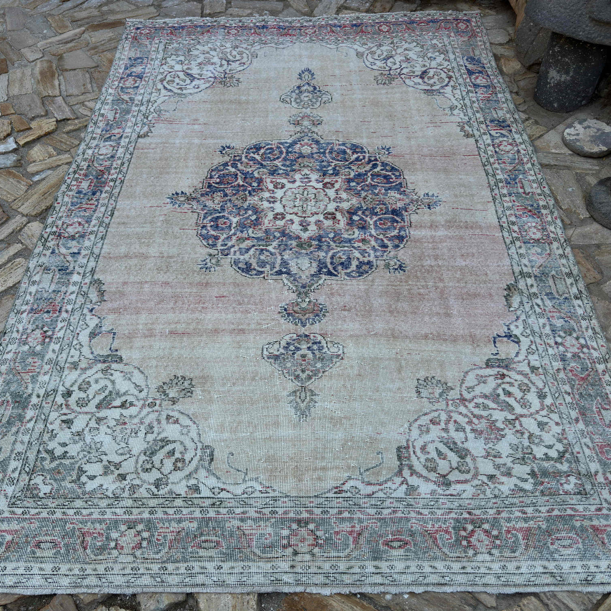Beige 7' x 10' vintage turkish rug in wool and cotton, shown on the floor.