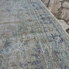 Close-up of the beige vintage turkish rug showing neutral details, hand-knotted weave, wool and cotton and low pile.