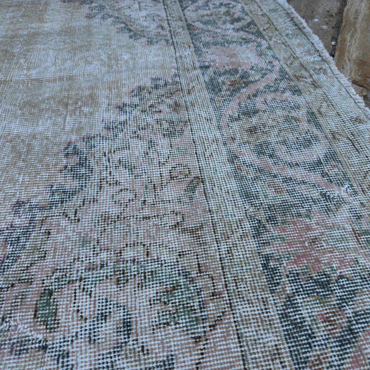 Close-up of the blue vintage turkish rug showing medallion details, hand-knotted weave, wool and cotton and low pile.