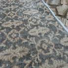 Close-up of the gray vintage turkish rug showing traditional details, hand-knotted weave, wool and cotton and low pile.