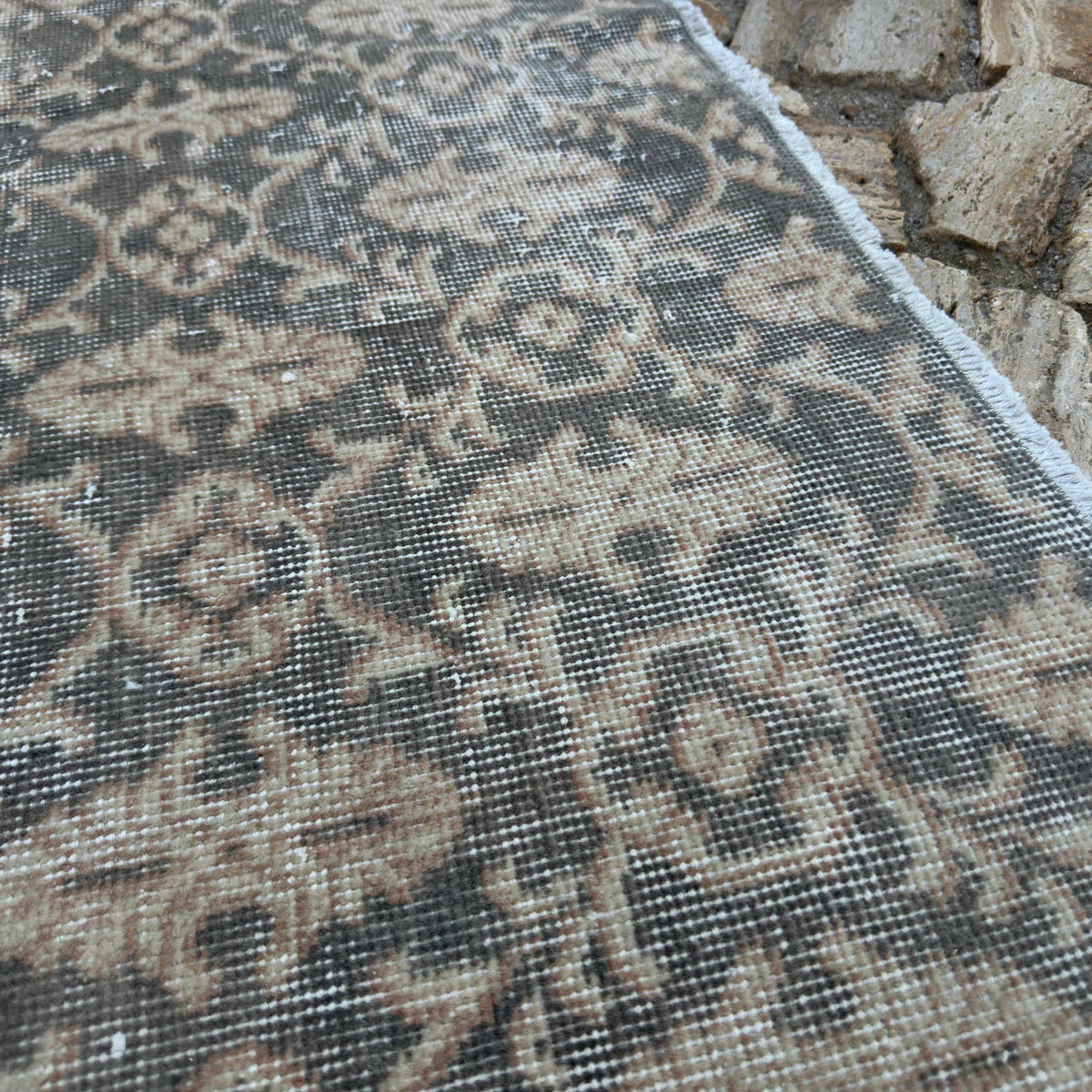 Close-up of the gray vintage turkish rug showing traditional details, hand-knotted weave, wool and cotton and low pile.
