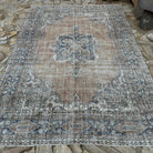 Orange 7' x 10' vintage turkish rug in wool and cotton, shown on the floor.