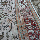 Close-up of the pink vintage turkish rug showing geometric details, hand-knotted weave, wool and cotton and low pile.