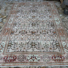 Pink 7' x 10' vintage turkish rug in wool and cotton, shown on the floor.