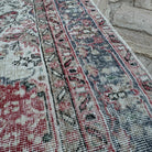 Close-up of the beige vintage turkish rug showing medallion details, hand-knotted weave, wool and cotton and low pile.