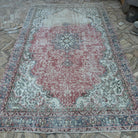 Beige 7' x 11' vintage turkish rug in wool and cotton, shown on the floor.