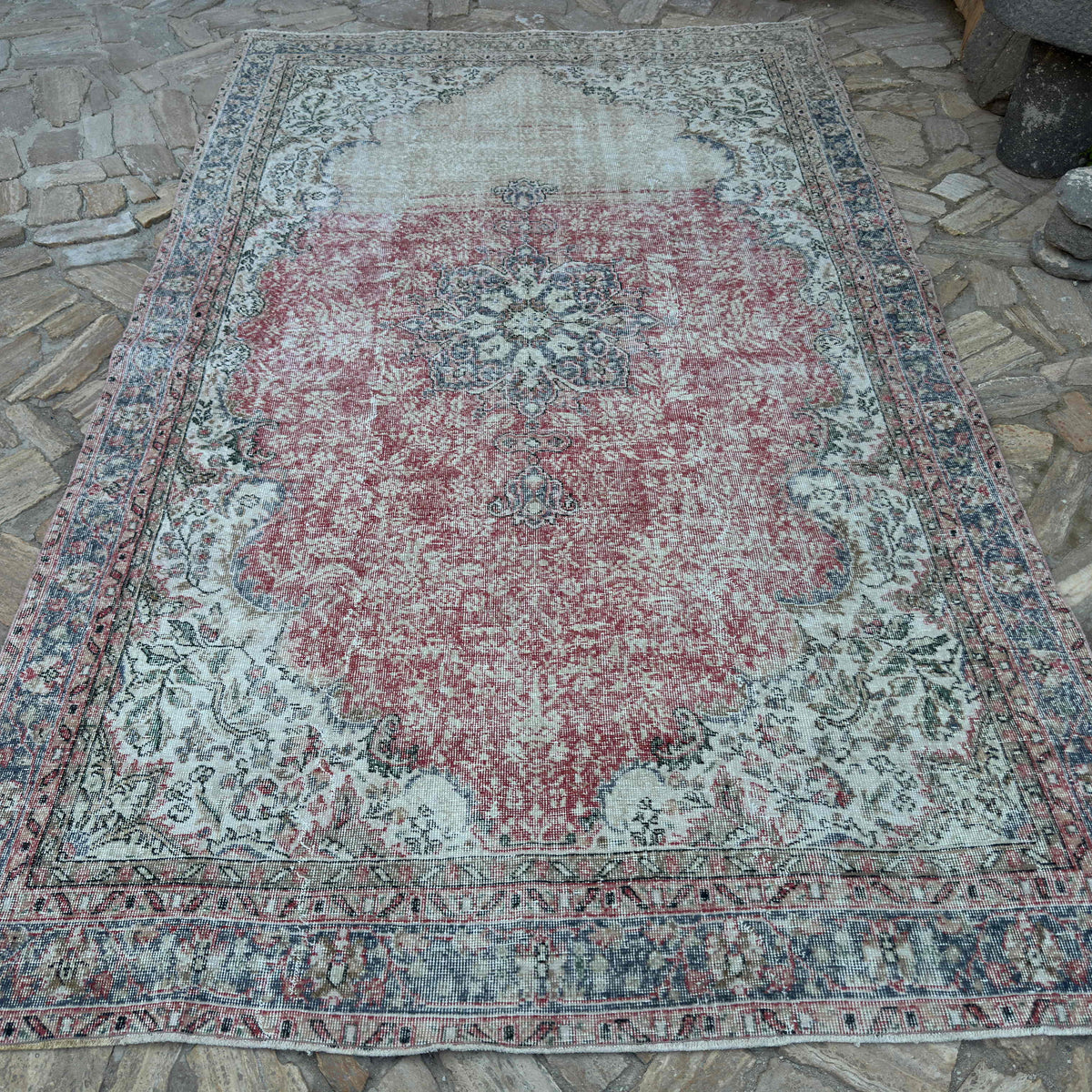 Beige 7' x 11' vintage turkish rug in wool and cotton, shown on the floor.