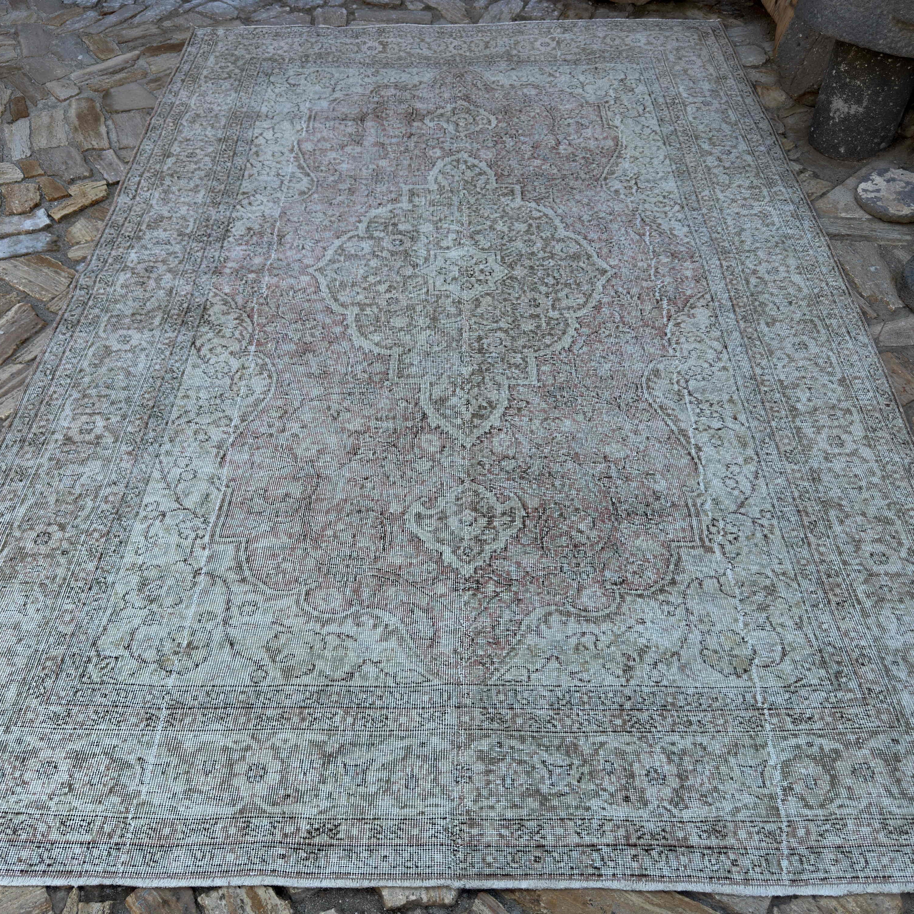 Pale Red 7' x 11' vintage turkish rug in wool and cotton, shown on the floor.